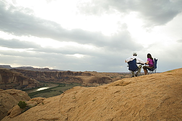 Couple in camping chairs over-looking canyon