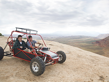 People in off-road vehicle on rock formation