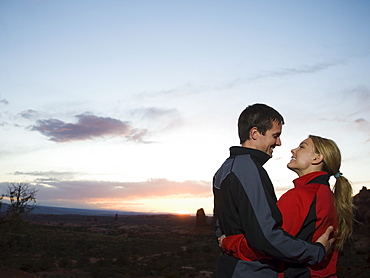 Couple in desert at dusk