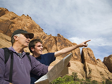 Father and son using map