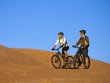 People riding mountain bikes