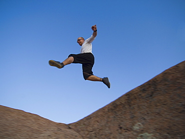 Man jumping over rock formations