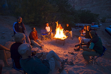 People relaxing around camp fire