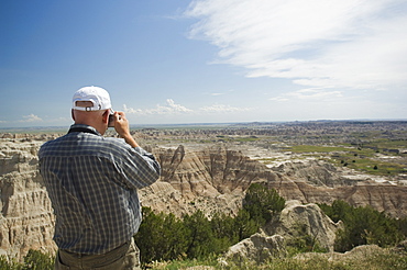 Man taking photograph of canyons