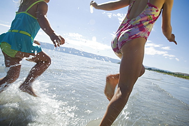 Sisters running in water, Utah, United States