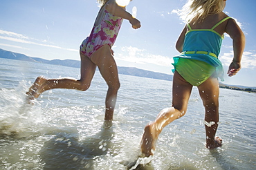 Sisters running in water, Utah, United States