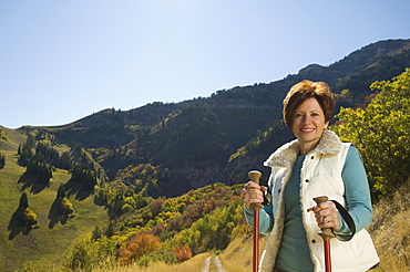 Senior woman holding hiking poles, Utah, United States