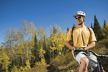 Man sitting on mountain bike, Utah, United States