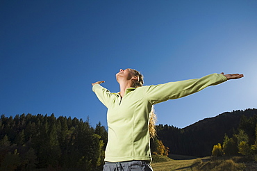 Woman with arms outstretched, Utah, United States