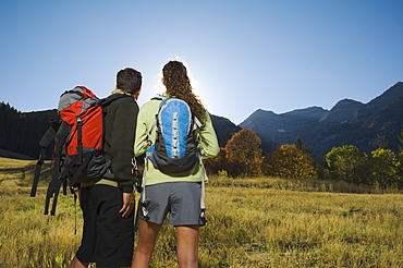 Couple wearing backpacks outdoors, Utah, United States