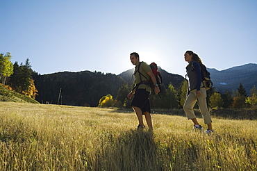 Couple hiking with backpacks, Utah, United States