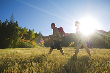 Couple hiking with backpacks, Utah, United States