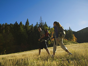 Couple hiking with backpacks, Utah, United States