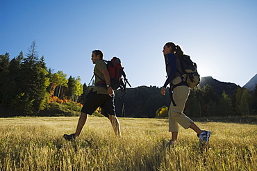 Couple hiking with backpacks, Utah, United States