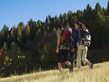 Couple hiking with backpacks, Utah, United States