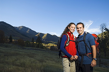 Couple wearing backpacks outdoors, Utah, United States