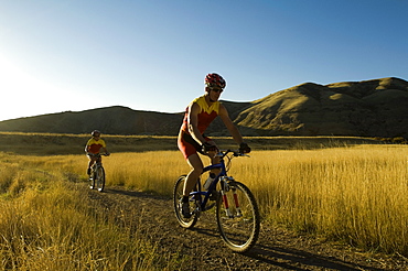 Couple riding mountain bikes, Salt Flats, Utah, United States