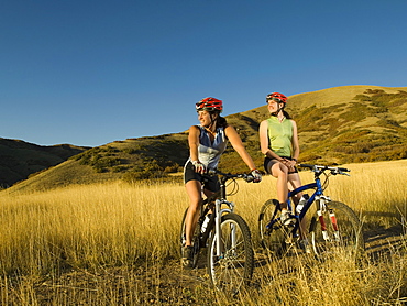 Two women on mountain bikes, Salt Flats, Utah, United States