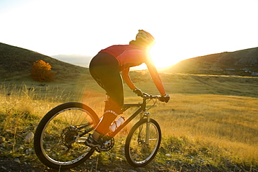 Woman riding mountain bike, Salt Flats, Utah, United States