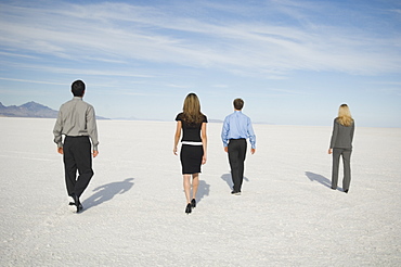 Businesspeople walking on salt flats, Salt Flats, Utah, United States