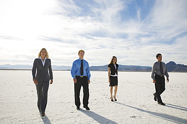 Businesspeople walking on salt flats, Salt Flats, Utah, United States