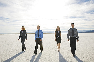 Businesspeople walking on salt flats, Salt Flats, Utah, United States