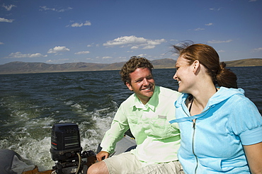 Couple on motorboat, Utah, United States