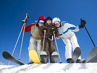 Family standing on skis