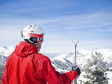 Man holding skis