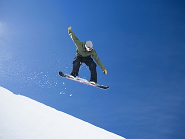 Man on snowboard in air