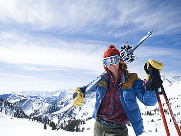 Woman holding skis on shoulder