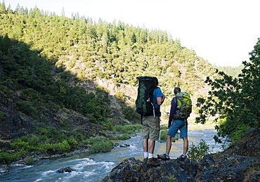 Hikers admiring view of river