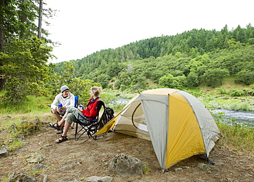 Couple relaxing at campsite