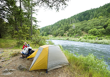 Couple relaxing at campsite