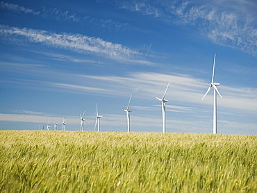 Windmills in a row on wind farm