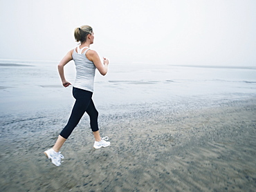 Woman jogging on beach