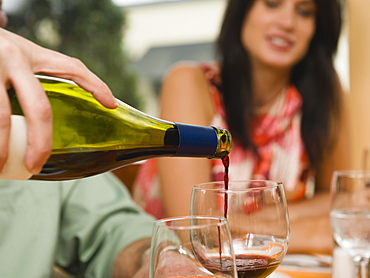 Waiter pouring wine in restaurant