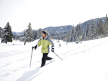 A woman snow shoeing