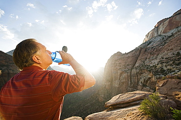 A man drinking water at Red Rock