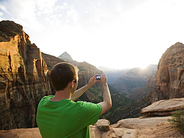 A man taking a picture at Red Rock