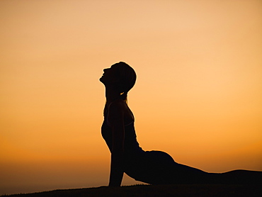 Silhouette of woman doing yoga