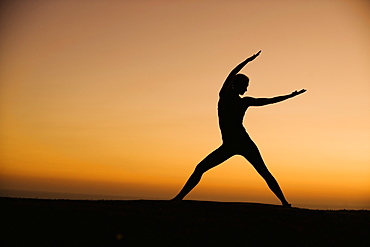 Silhouette of woman doing yoga