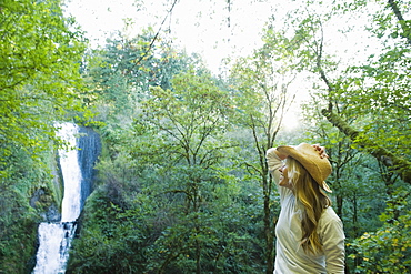 Hiker looking at waterfall