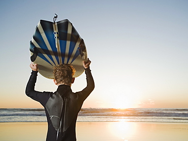 Child holding surfboard