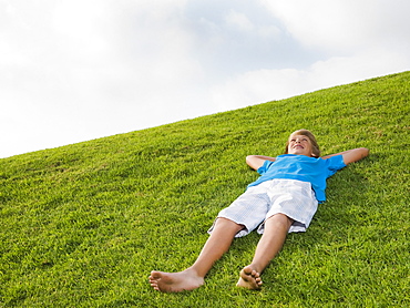 Boy resting on grass