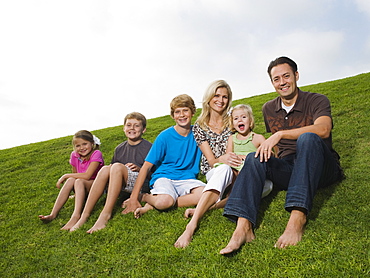 Family sitting on grass