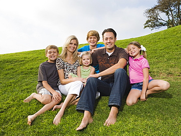 Family sitting on grass