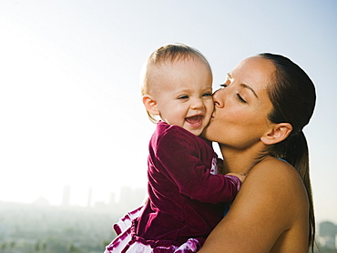 Woman kissing toddler