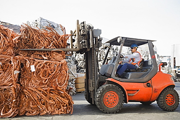 Forklift driver working at recycling plant