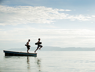 Boys (10-11,12-13) jumping from raft